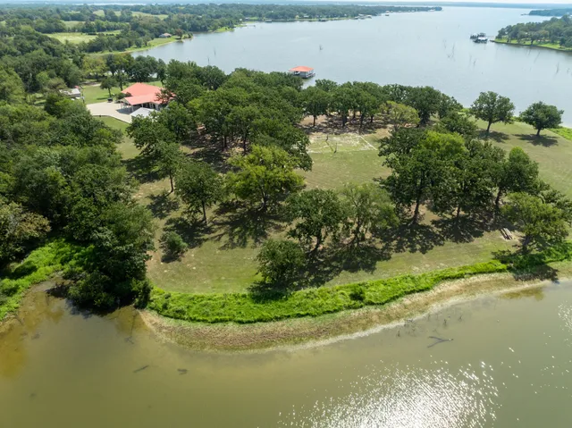a view of a lake with a yard and mountain view