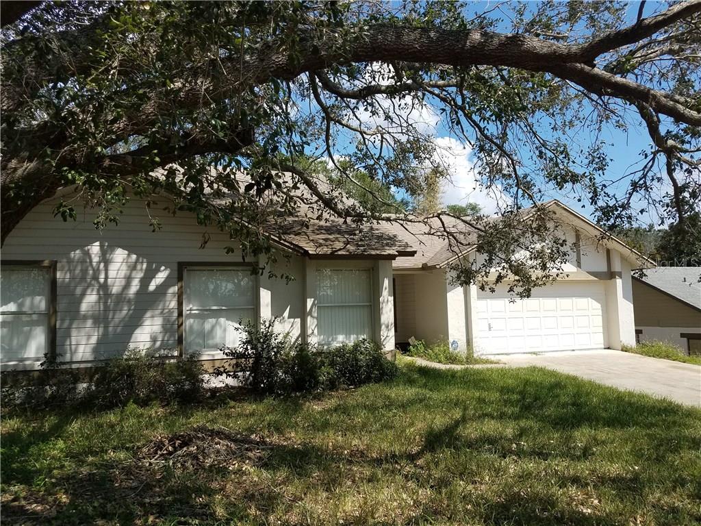 8038 Sweetgum Loop Orlando, FL 32835 - Photo 1 of 1 a house that has a tree in it