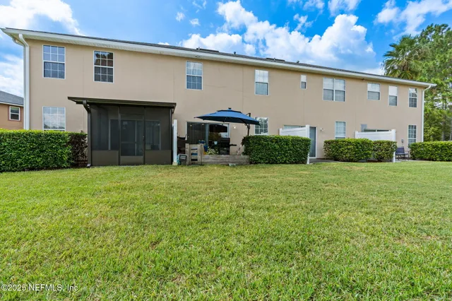 a front view of a house with garden and sitting area