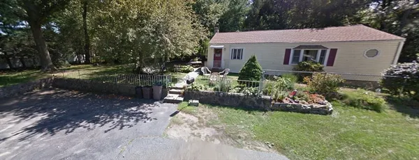 a view of a house with a yard and garden