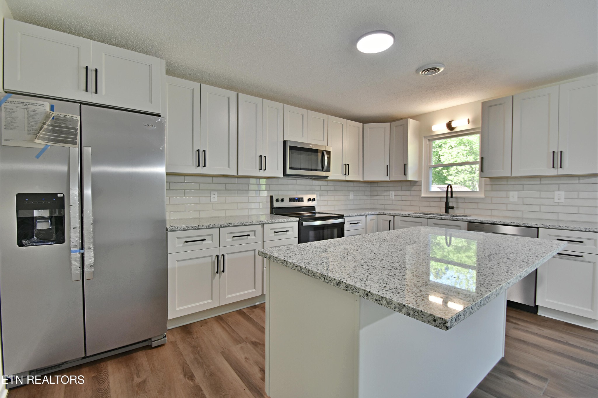 1119 Rudd Road Greenback, TN 37742 - Photo 9 of 28 a kitchen with granite countertop stainless steel appliances a refrigerator sink and microwave
