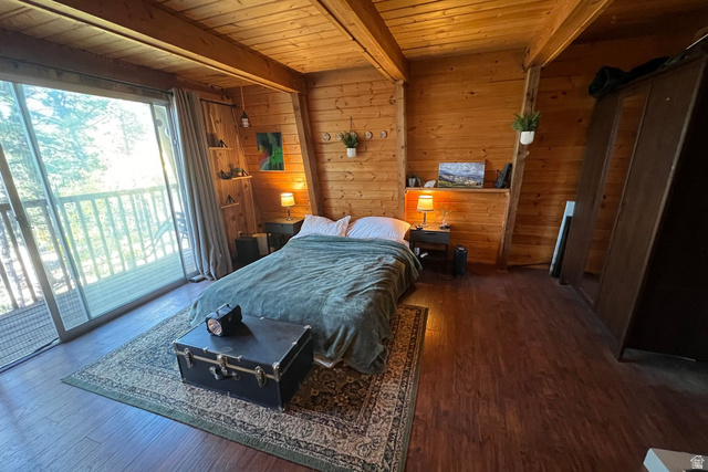 140 East Rim Road Duck Creek Village, UT 84762 - Photo 5 of 45 Bedroom featuring wood walls, a wooden ceiling with exposed beams, access to outside, and dark wood-type flooring