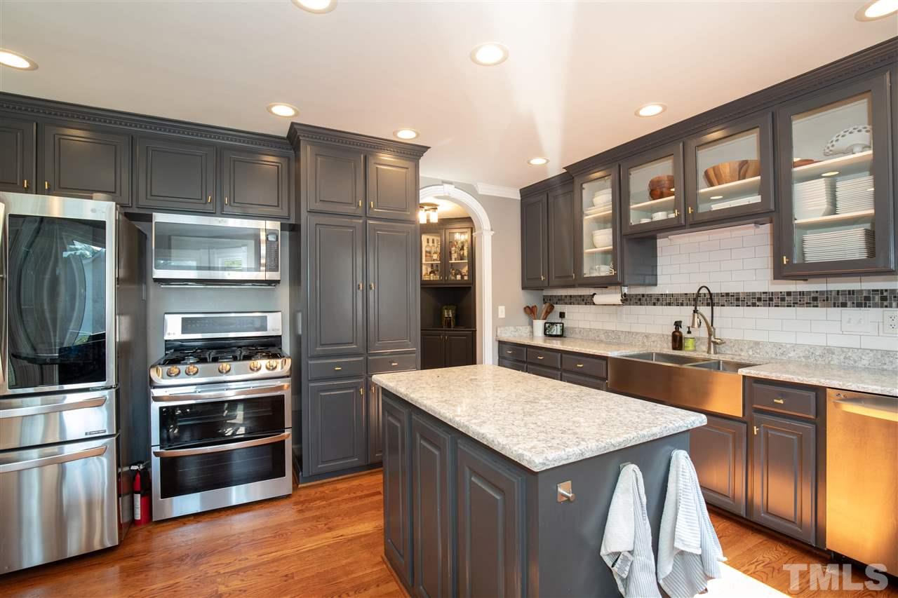 715 Rosemont Avenue Raleigh, NC 27607 - Photo 8 of 26 a kitchen with a refrigerator and a sink