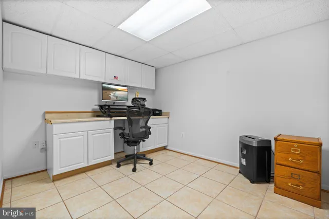 an empty room with windows and ceiling fan
