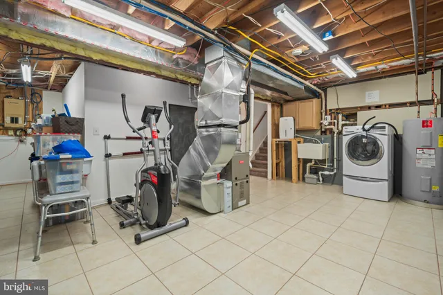 an empty room with chandelier fan and windows