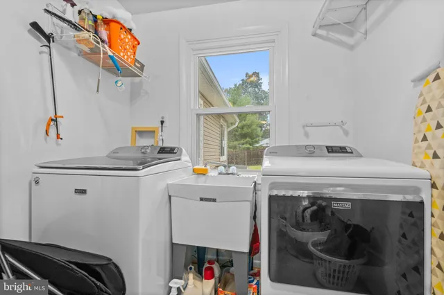 a kitchen with stainless steel appliances granite countertop a sink a stove and cabinets