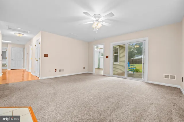 a kitchen with granite countertop a sink window and cabinets