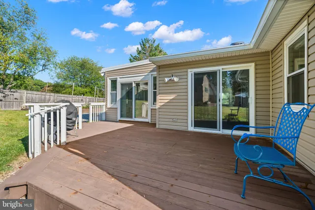 a view of a house with a big yard and large trees