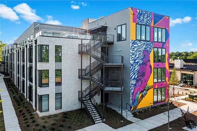 a front view of multi story residential apartment building with yard