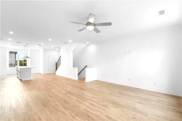 a view of a kitchen with a sink and a refrigerator