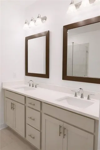 a bathroom with double sink and a mirror
