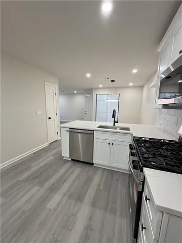 a kitchen with stainless steel appliances a refrigerator sink and cabinets