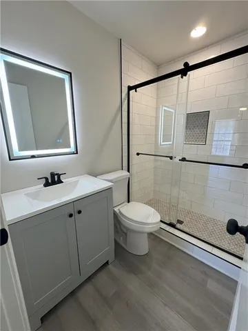 a bathroom with a toilet sink and shower