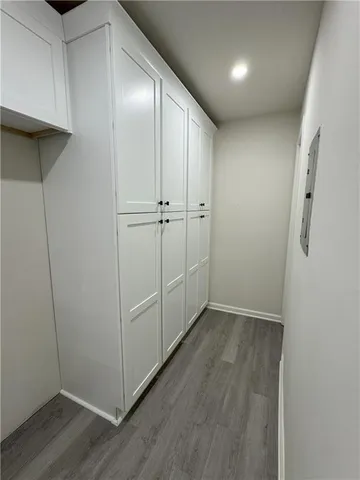 a view of hallway with wooden floor