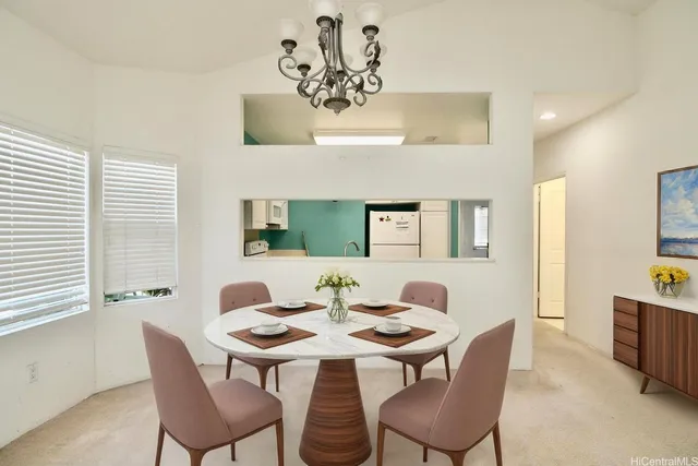 a view of a dining room with furniture and chandelier