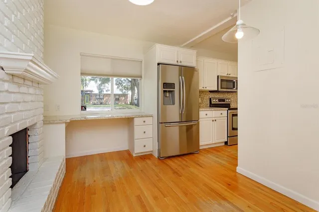 a kitchen with stainless steel appliances a refrigerator and a stove top oven