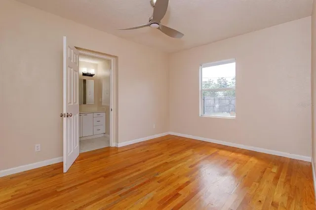 wooden floor in an empty room with a window