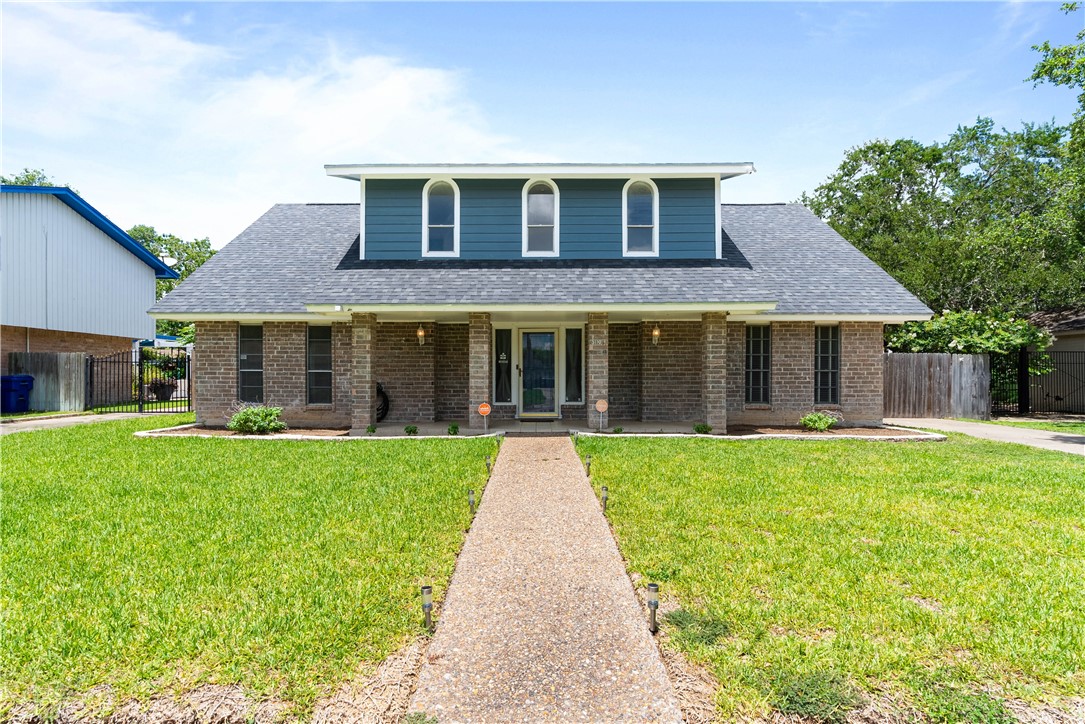 a front view of a house with a yard and porch