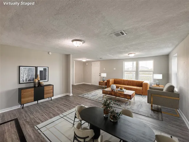 a living room with furniture and wooden floor