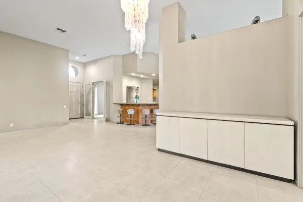 a dining hall with stainless steel appliances granite countertop a sink and a large window