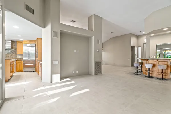 a kitchen with stainless steel appliances granite countertop a refrigerator a oven and a sink