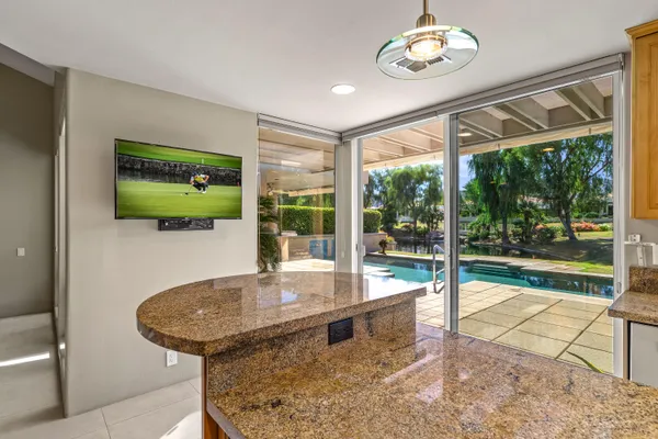 a bathroom with a granite countertop sink a large mirror and a shower