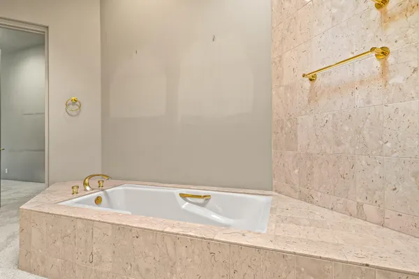 a view of bathroom with a tub and shower