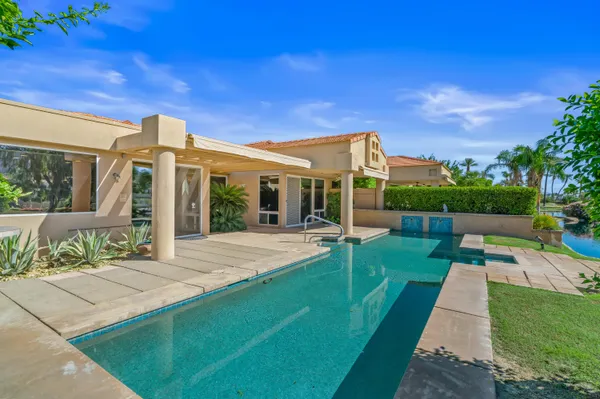 a view of a house with a backyard porch and sitting area