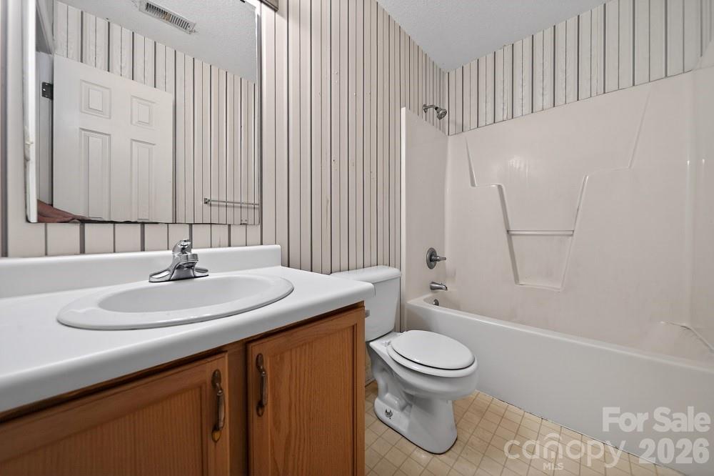 2205 Old Sparta Road Rocky Mount, NC 27804 - Photo 23 of 25 a bathroom with a sink a toilet and a large mirror