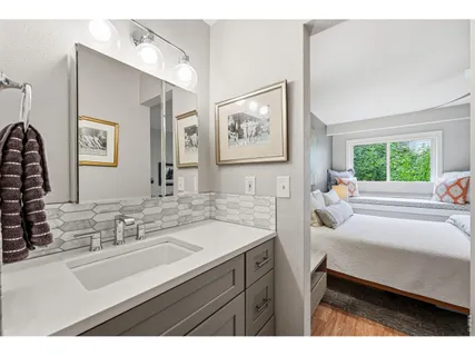 a bathroom with a sink a shower and a mirror