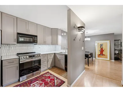 a kitchen with granite countertop a stove top oven and cabinets
