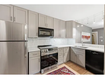 a kitchen with a sink appliances and cabinets