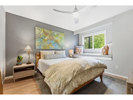 a bedroom with a bed mirror and window