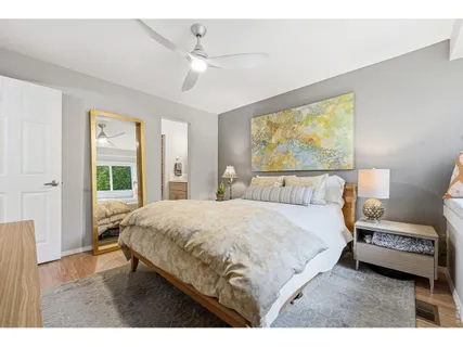 a spacious bedroom with a bed and a chandelier