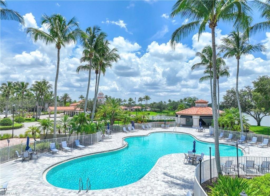 4453 Novato Court Naples, FL 34109 - Photo 5 of 7 a view of a swimming pool with a patio and a yard
