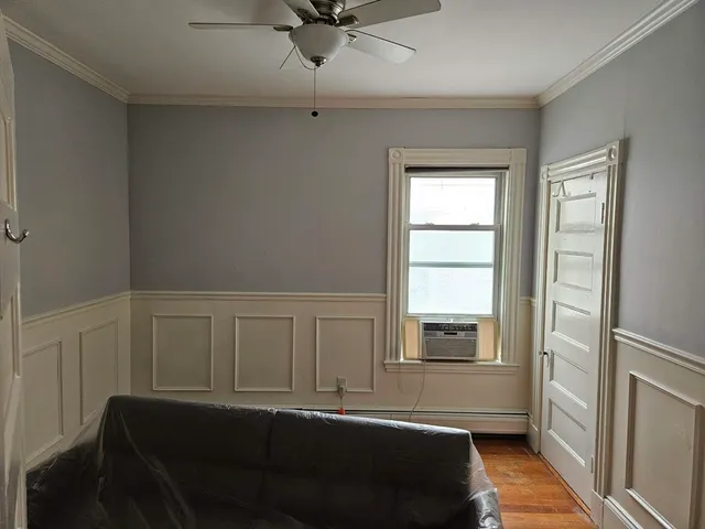 a living room with a bed furniture and a window