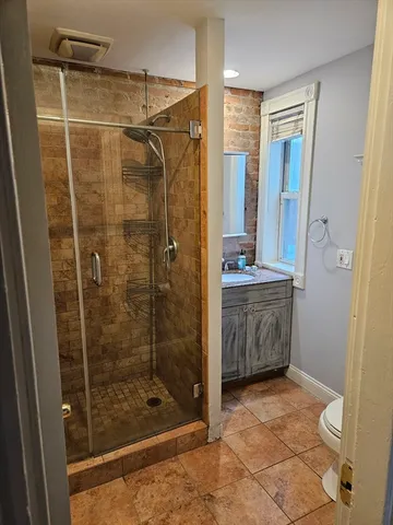 a bathroom with a shower and a sink