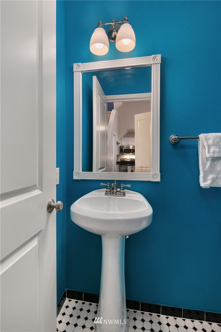 2415 2nd Avenue, Unit 734 Seattle, WA 98121 - Photo 11 of 23 a bathroom with a sink a mirror and window