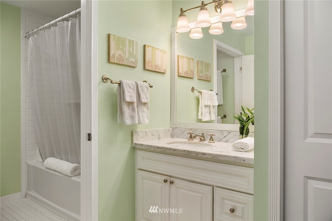 2415 2nd Avenue, Unit 734 Seattle, WA 98121 - Photo 14 of 23 a bathroom with a sink a mirror and a shower