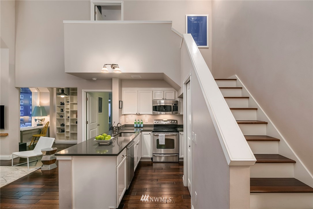 2415 2nd Avenue, Unit 734 Seattle, WA 98121 - Photo 15 of 23 a kitchen with stainless steel appliances granite countertop a stove and a sink