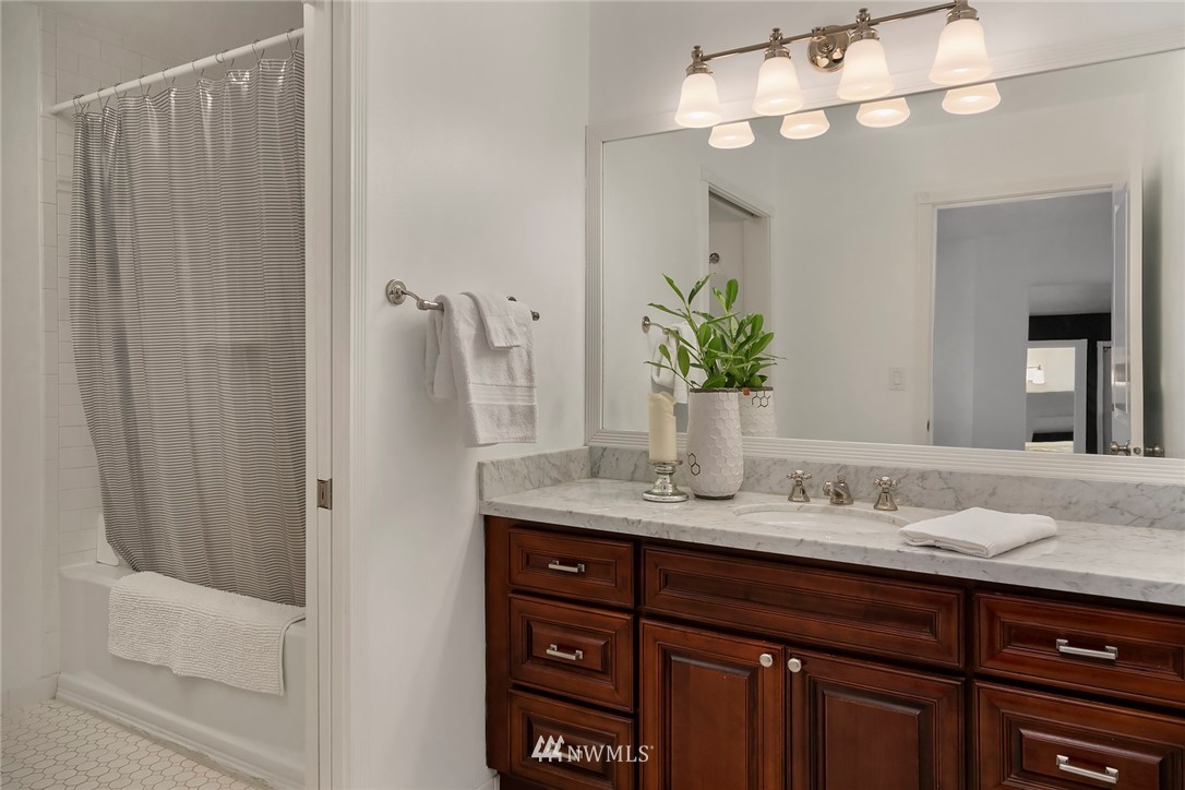 2415 2nd Avenue, Unit 734 Seattle, WA 98121 - Photo 19 of 23 a bathroom with a double vanity sink and a mirror