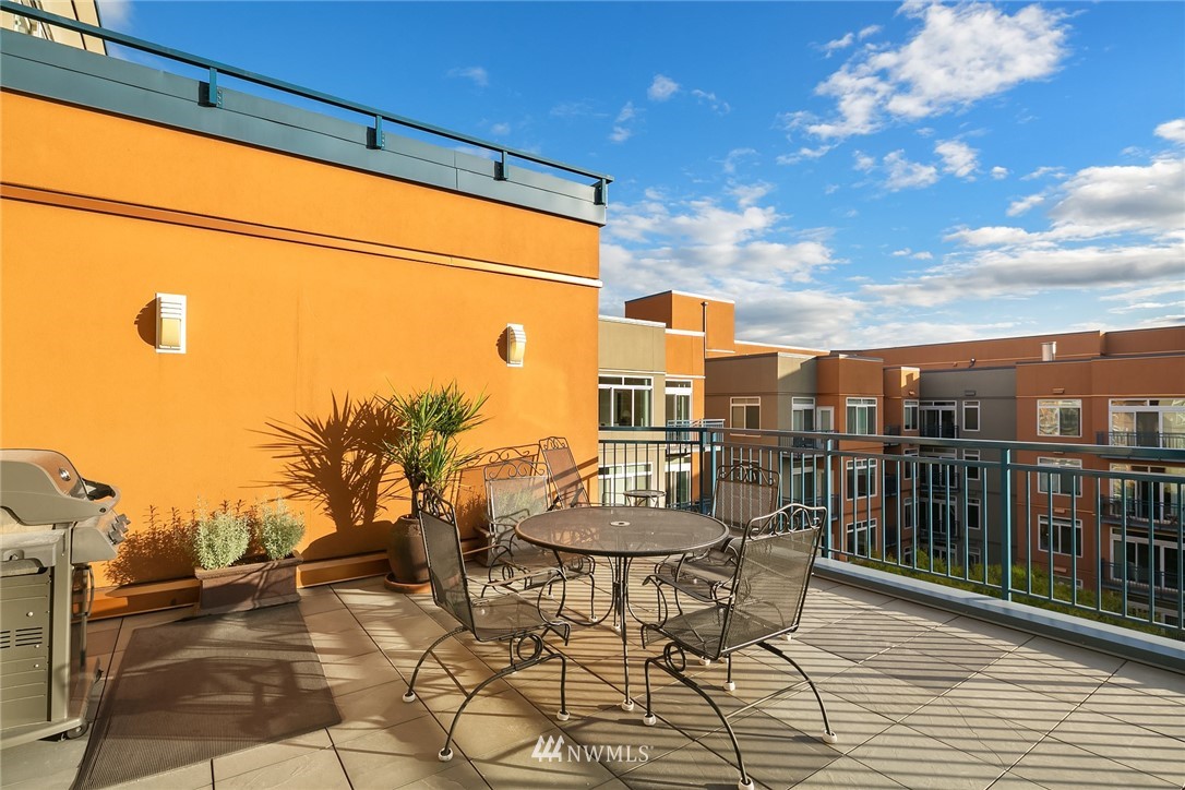 2415 2nd Avenue, Unit 734 Seattle, WA 98121 - Photo 20 of 23 a view of a terrace with furniture and city view