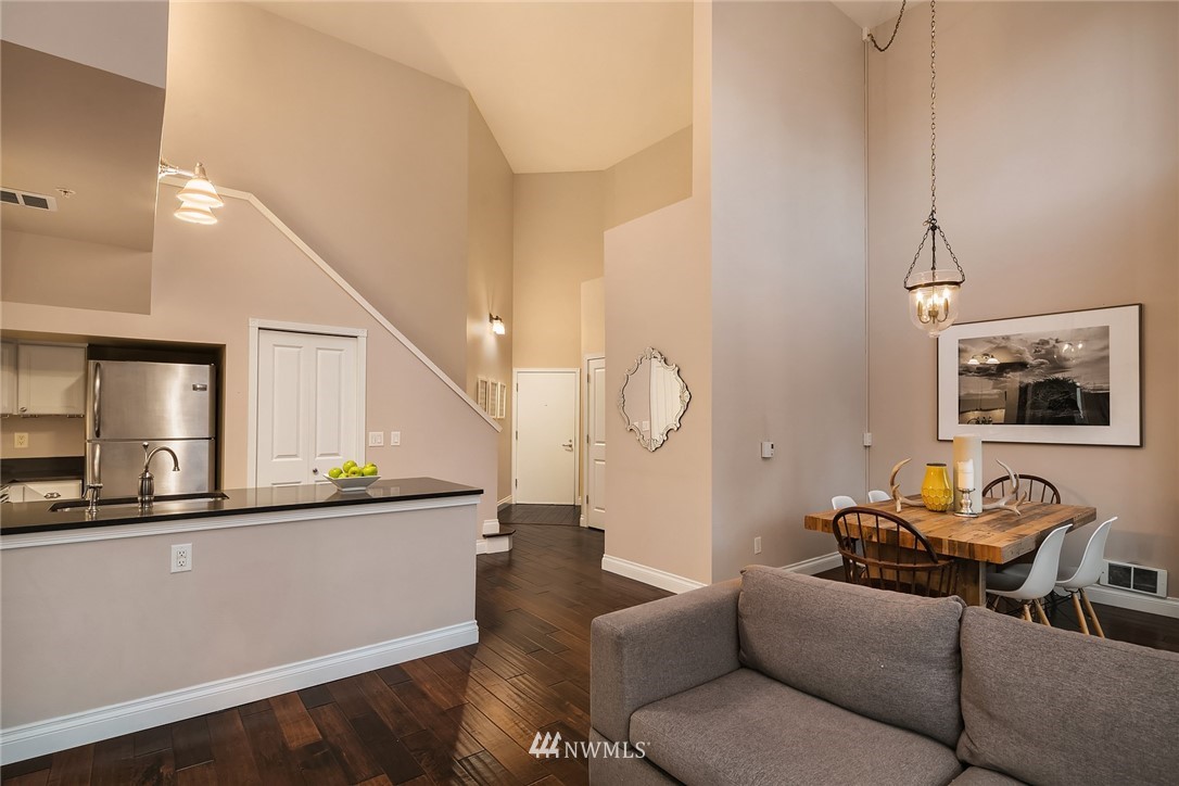 2415 2nd Avenue, Unit 734 Seattle, WA 98121 - Photo 9 of 23 a living room with furniture and wooden floor