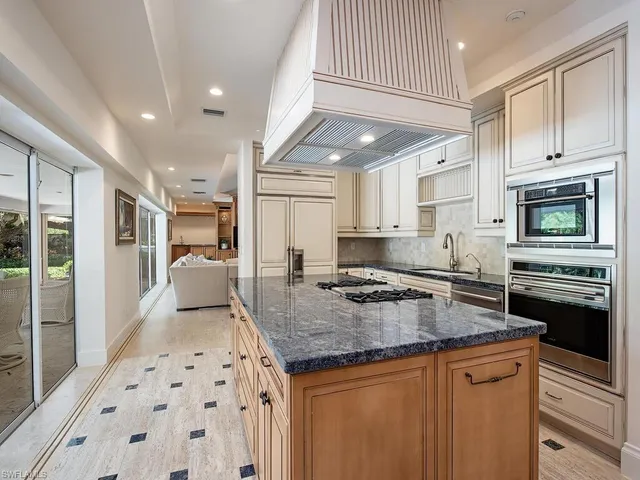 a kitchen with stainless steel appliances granite countertop a stove sink and cabinets