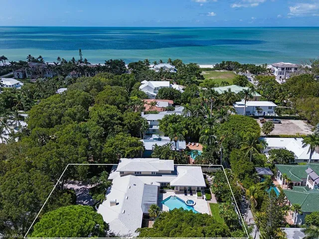 an aerial view of a house with a lake view