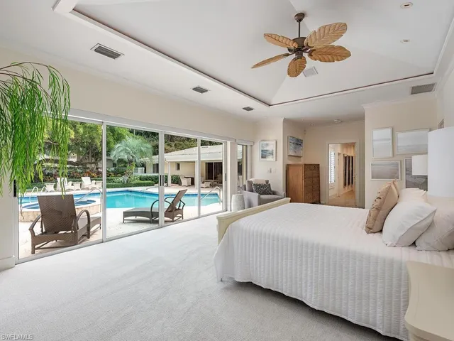 a living room with furniture large window and flat screen tv