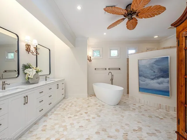a bathroom with a tub sink and mirror