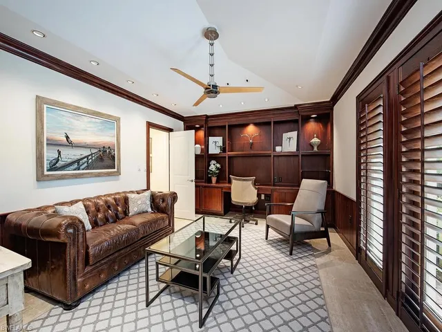 a bathroom with a granite countertop toilet sink and mirror