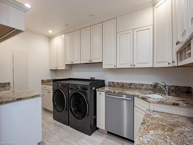 a utility room with sink dryer and washer