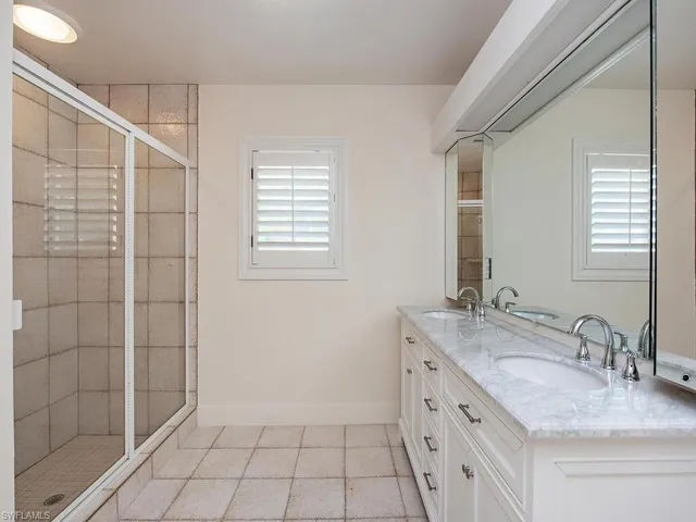 a bedroom with a large bed and a large window